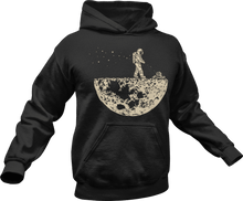 Load image into Gallery viewer, Astronaut mowing the moon printed on a black hoodie
