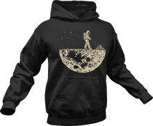 Load image into Gallery viewer, Astronaut mowing the moon printed on a black hoodie