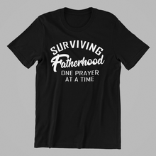 Load image into Gallery viewer, Surviving Fatherhood One Prayer at a Time T-shirtboy, brother, christian, dad, family, funny, Mens, motivation, nephew, uncle, Unisex