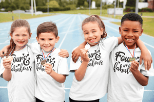 Four and fabulous printed on a group of kids holding their champion medals white t-shirts
