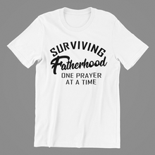 Load image into Gallery viewer, Surviving Fatherhood One Prayer at a Time T-shirtboy, brother, christian, dad, family, funny, Mens, motivation, nephew, uncle, Unisex
